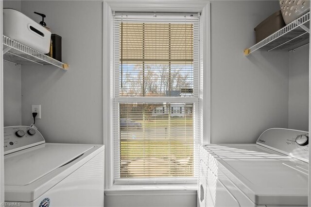 washroom featuring plenty of natural light and washing machine and clothes dryer