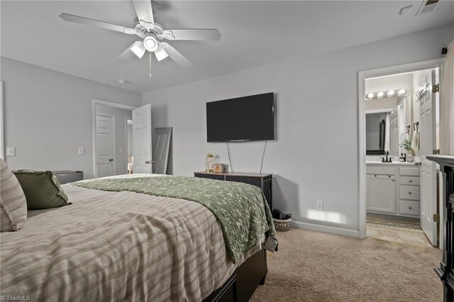 carpeted bedroom featuring connected bathroom, ceiling fan, and sink