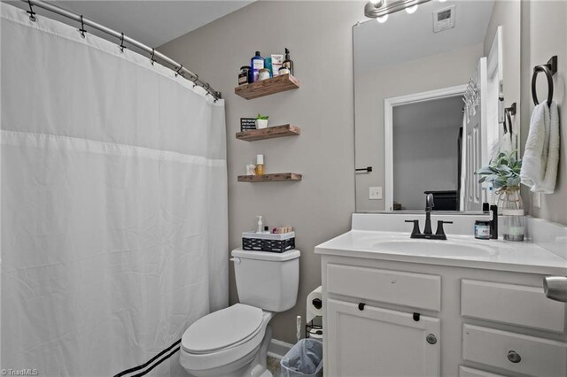 bathroom featuring vanity and toilet