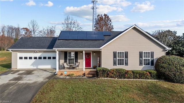 ranch-style home featuring solar panels, a garage, covered porch, and a front yard