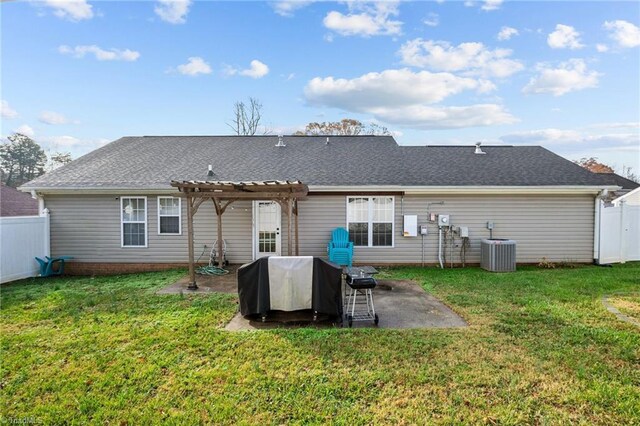 rear view of property with central AC unit, a pergola, a yard, and a patio