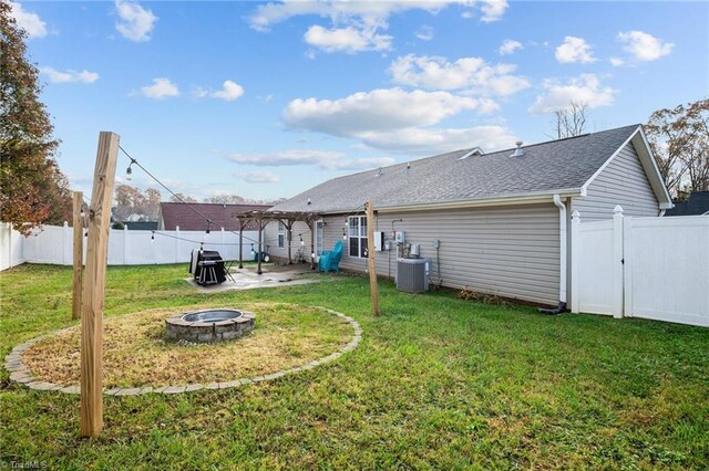 view of yard featuring cooling unit, a patio, and an outdoor fire pit