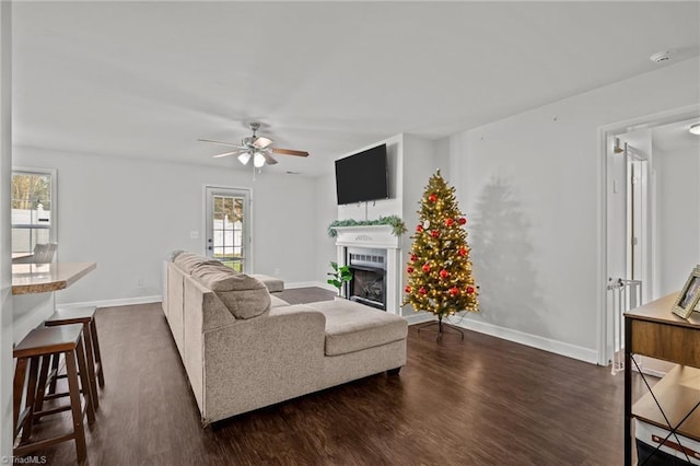 living room featuring dark hardwood / wood-style floors and ceiling fan