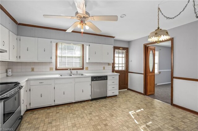 kitchen with tasteful backsplash, light countertops, appliances with stainless steel finishes, white cabinetry, and a sink