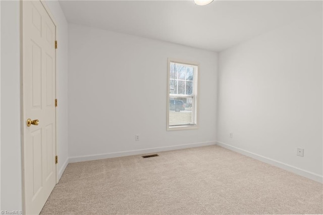 unfurnished bedroom featuring light carpet, visible vents, and baseboards