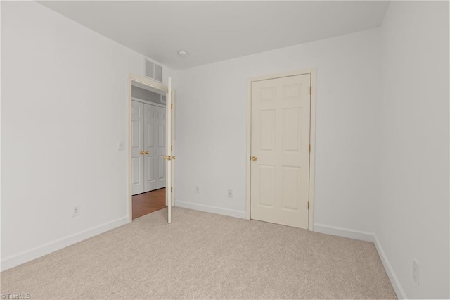 unfurnished bedroom featuring carpet, visible vents, and baseboards