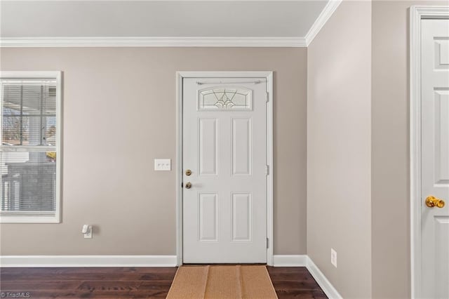 foyer with crown molding, dark wood finished floors, and baseboards