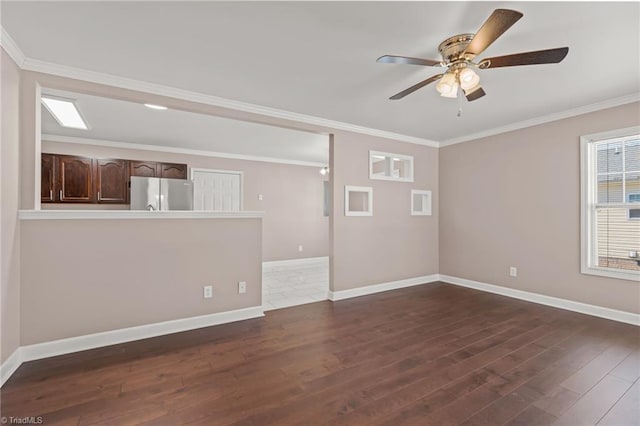 unfurnished room with ornamental molding, dark wood finished floors, baseboards, and ceiling fan