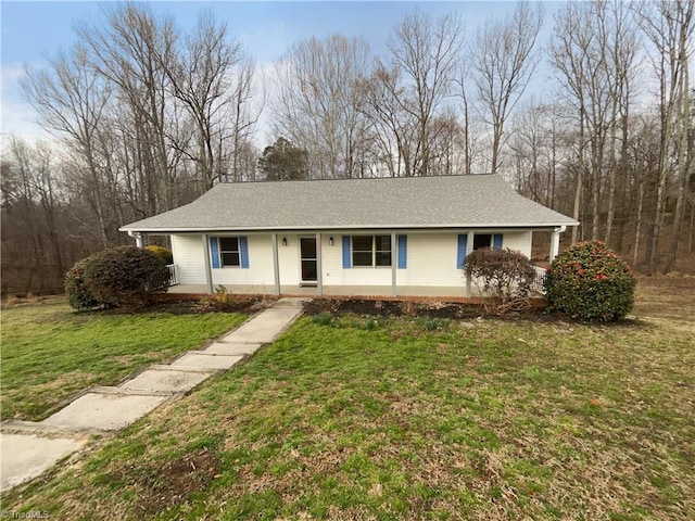 ranch-style house with a front yard, covered porch, and roof with shingles