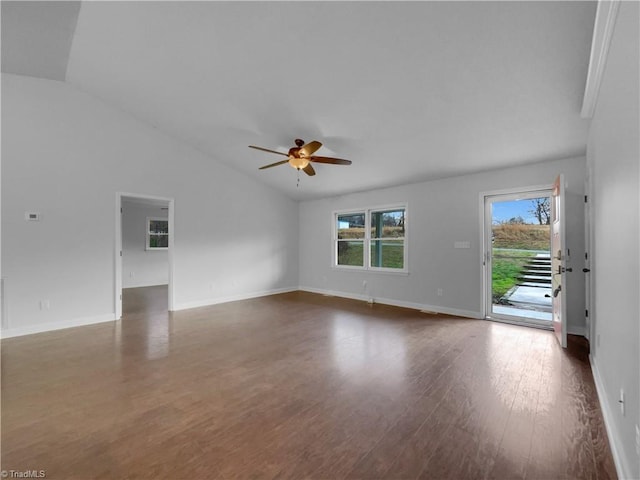 unfurnished living room with baseboards, ceiling fan, dark wood-style flooring, and vaulted ceiling