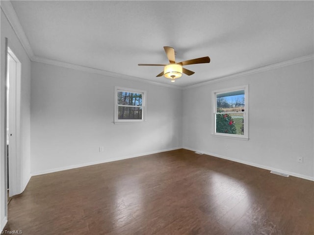 unfurnished room featuring a ceiling fan, crown molding, dark wood-style floors, and baseboards