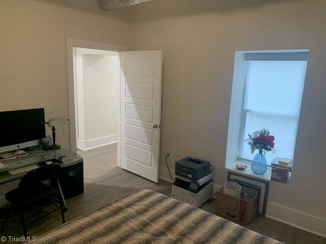 bedroom featuring dark wood-type flooring