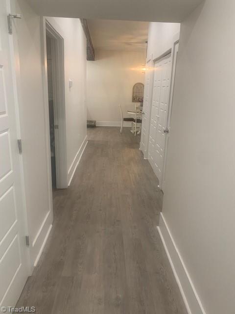 hallway with dark hardwood / wood-style floors