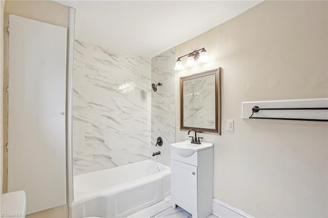 bathroom featuring tiled shower / bath and vanity