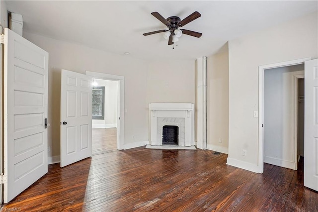 unfurnished living room featuring ceiling fan, dark hardwood / wood-style floors, and a high end fireplace