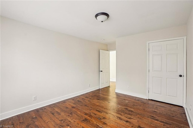 unfurnished bedroom featuring dark hardwood / wood-style floors