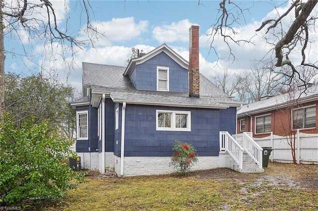 rear view of house featuring a yard and central air condition unit