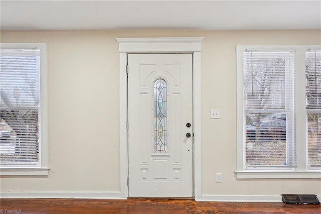 entryway with dark hardwood / wood-style floors