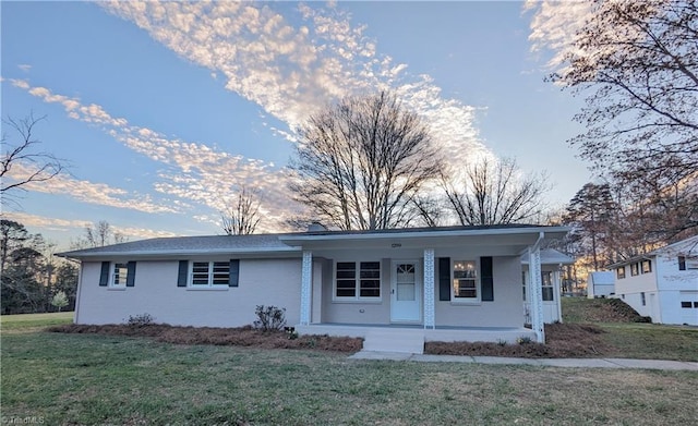 ranch-style home featuring a porch and a front yard