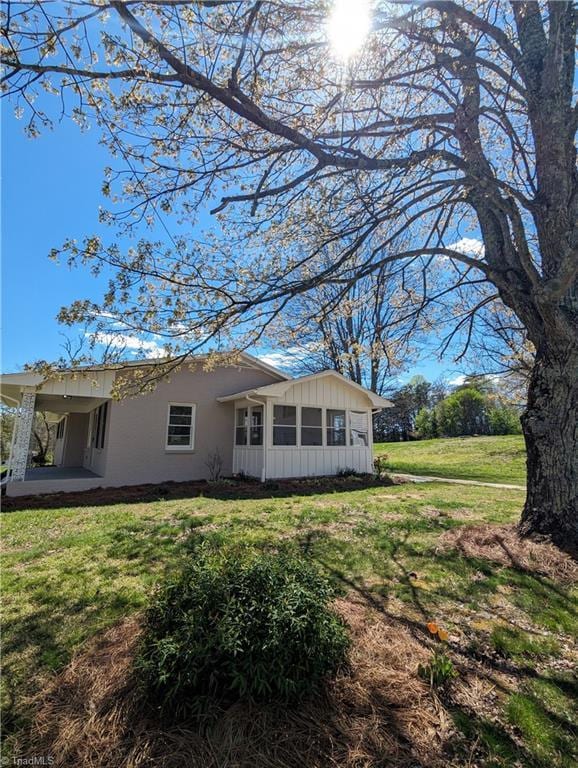 rear view of house with a yard