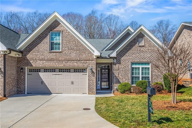 view of front of house featuring roof with shingles, concrete driveway, an attached garage, a front yard, and brick siding