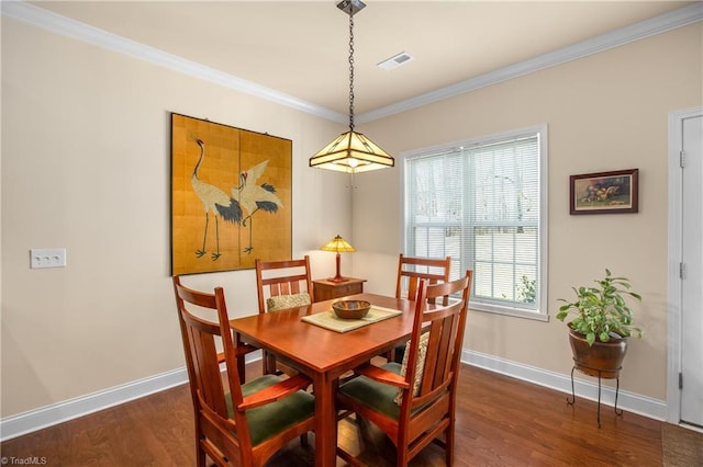 dining space with visible vents, baseboards, wood finished floors, and ornamental molding