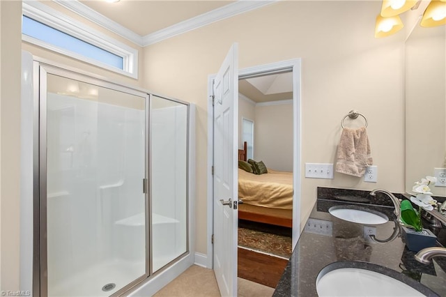 ensuite bathroom with ornamental molding, a stall shower, and a sink