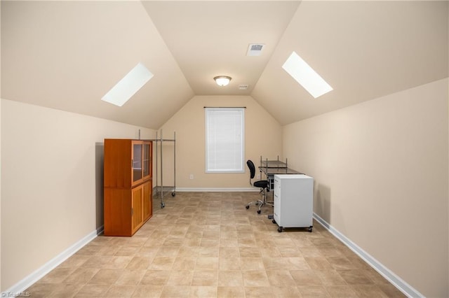 office featuring visible vents, lofted ceiling with skylight, and baseboards