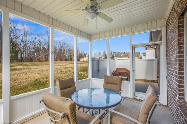 sunroom featuring a wealth of natural light, wooden ceiling, and a ceiling fan