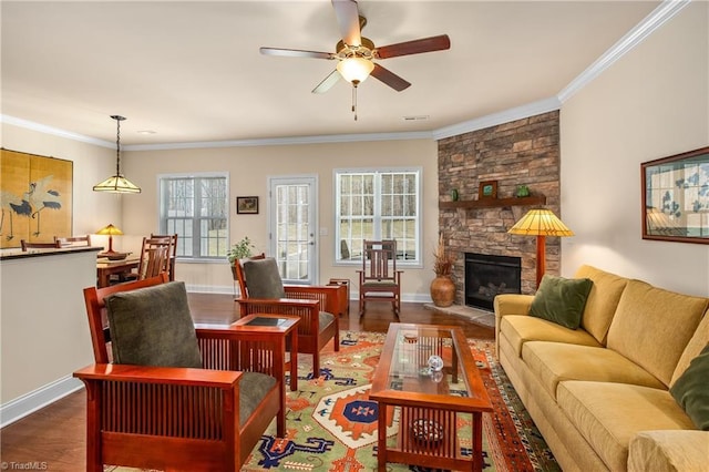 living area featuring visible vents, a stone fireplace, wood finished floors, and crown molding