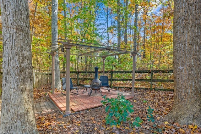 wooden terrace with a pergola and a fire pit