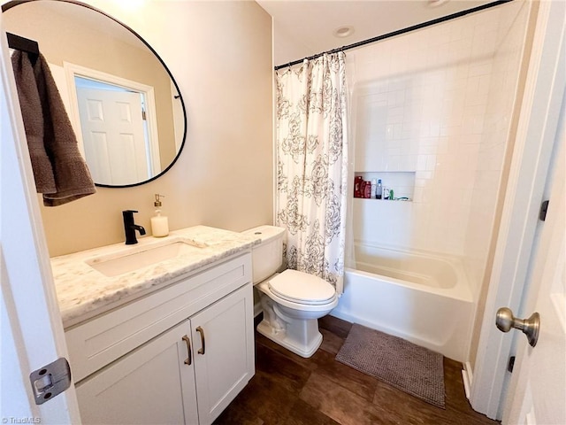 full bathroom featuring shower / bath combo with shower curtain, vanity, and toilet