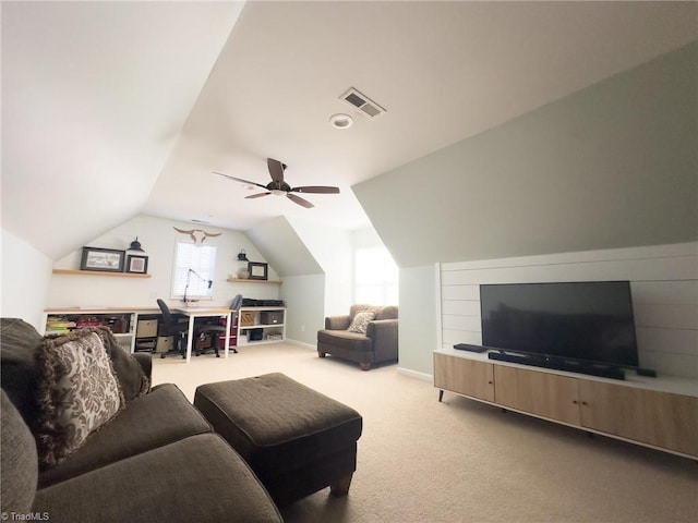 carpeted living room with ceiling fan and lofted ceiling