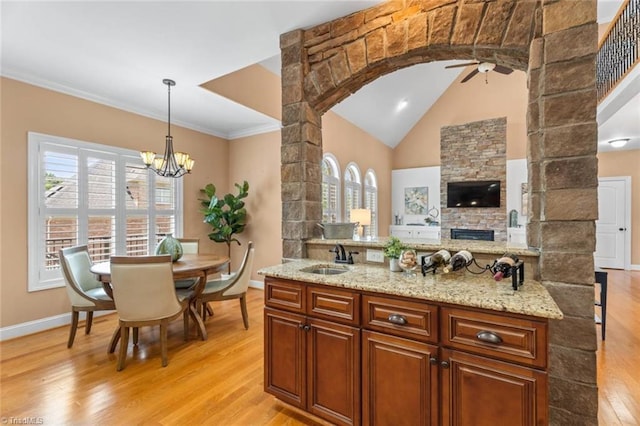 142 Covington Pl, Lewisville, NC 27023 - kitchen with a ceiling fan, light wood-style floors, pendant lighting, healthy amount of natural light, and ornamental molding