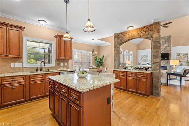 142 Covington Pl, Lewisville, NC 27023 - kitchen with light wood finished floors, open floor plan, tasteful backsplash, light stone counters, and pendant lighting