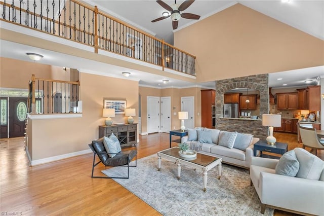 142 Covington Pl, Lewisville, NC 27023 - living room featuring high vaulted ceiling, a ceiling fan, light wood-type flooring, and ornamental molding