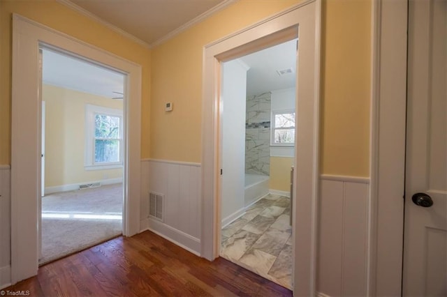 corridor featuring dark hardwood / wood-style floors and ornamental molding