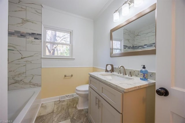 bathroom with crown molding, vanity, and toilet