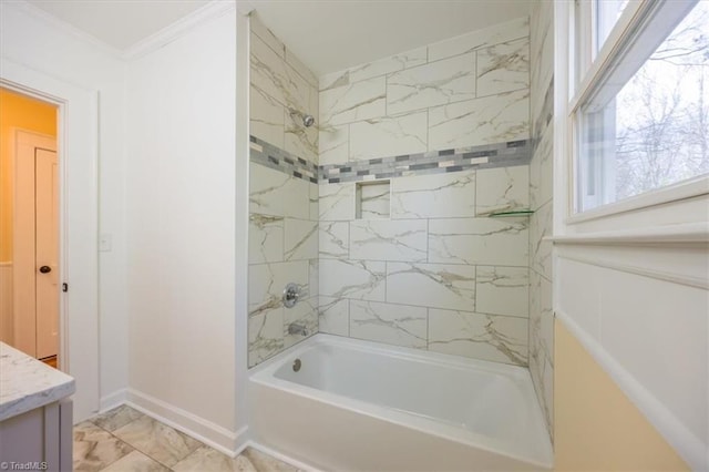 bathroom featuring vanity, tiled shower / bath, and crown molding