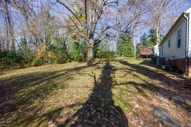 view of yard featuring central air condition unit