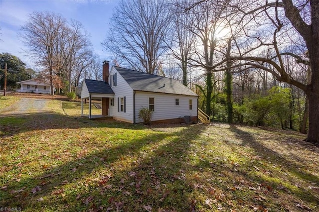 view of home's exterior with a yard and central AC unit