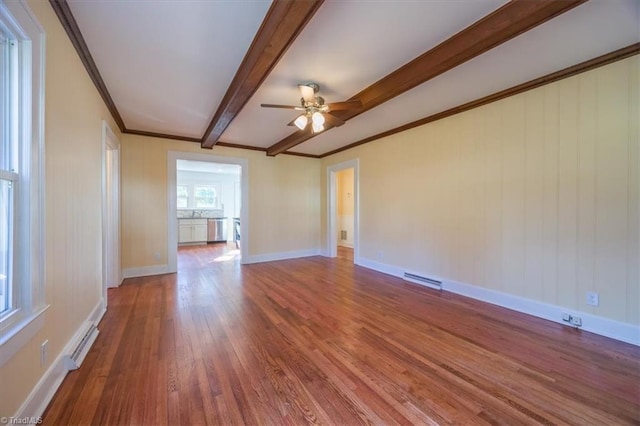 empty room featuring beam ceiling, ceiling fan, hardwood / wood-style floors, and ornamental molding