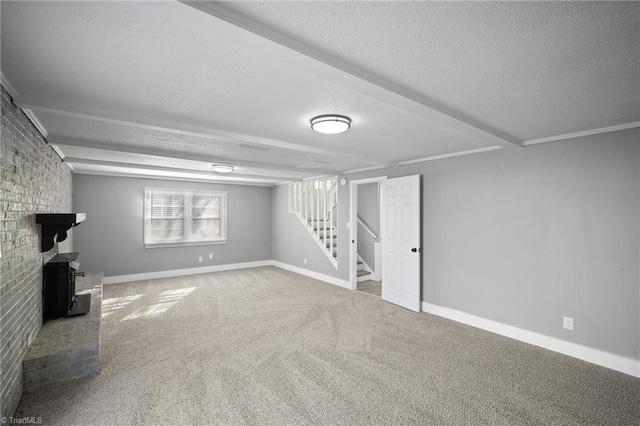 below grade area featuring carpet floors, baseboards, stairway, and a textured ceiling