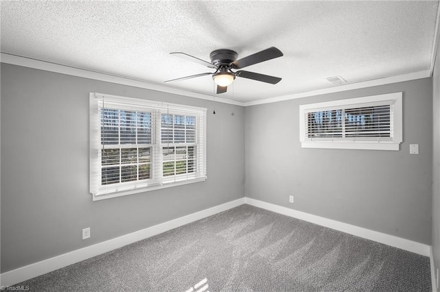 unfurnished room featuring ornamental molding, carpet, a textured ceiling, and baseboards