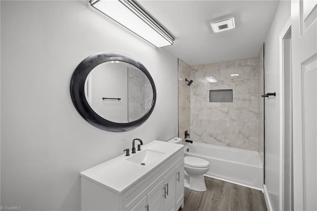 bathroom featuring bathtub / shower combination, visible vents, toilet, vanity, and wood finished floors