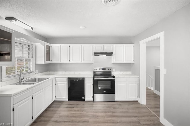 kitchen featuring under cabinet range hood, a sink, white cabinetry, stainless steel electric range, and dishwasher