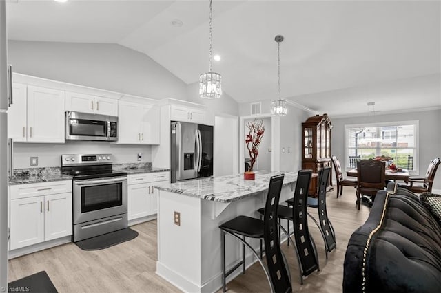 111 Brooke Ridge Dr, Thomasville, NC 27360 - kitchen with appliances with stainless steel finishes, vaulted ceiling, white cabinets, and light wood-style flooring