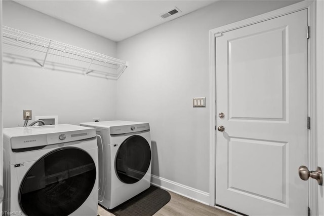 111 Brooke Ridge Dr, Thomasville, NC 27360 - washroom featuring independent washer and dryer, light wood-type flooring, and baseboards