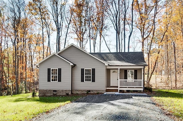 ranch-style house featuring a porch and a front yard