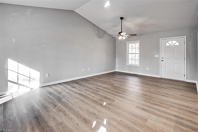 unfurnished living room featuring hardwood / wood-style floors, ceiling fan, and lofted ceiling